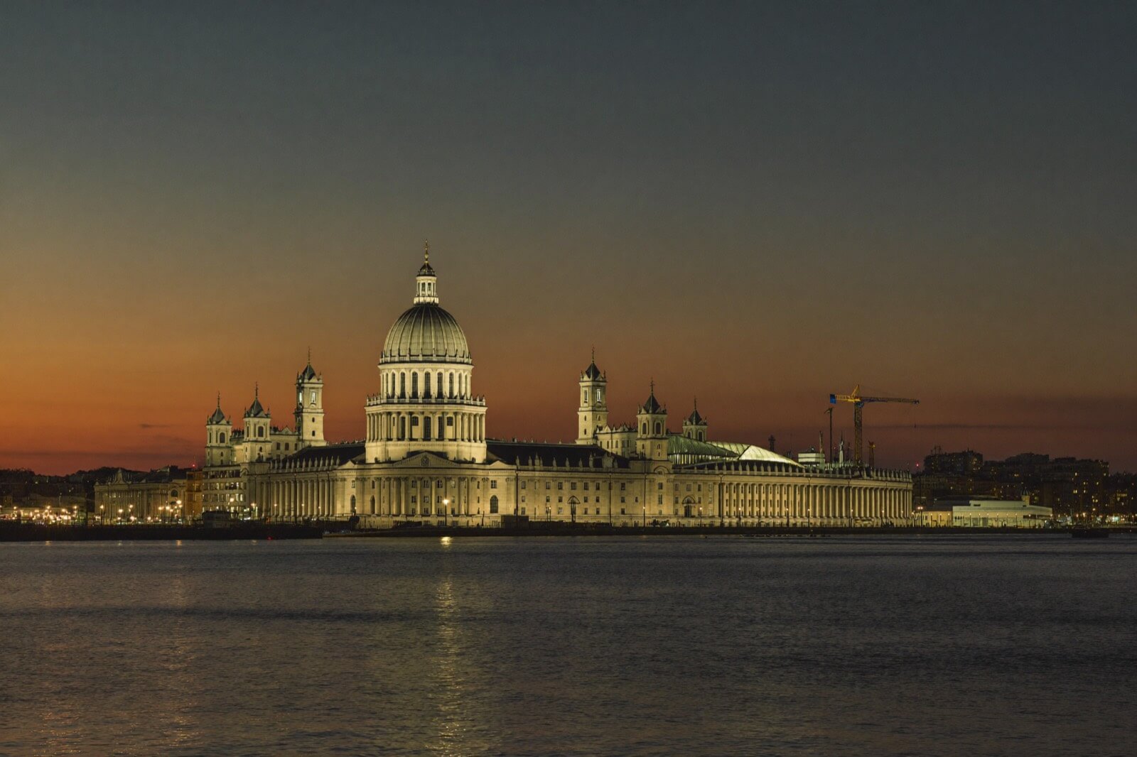 Liverpool waterfront at dusk with the Royal Liver Building lit up over the River Mersey