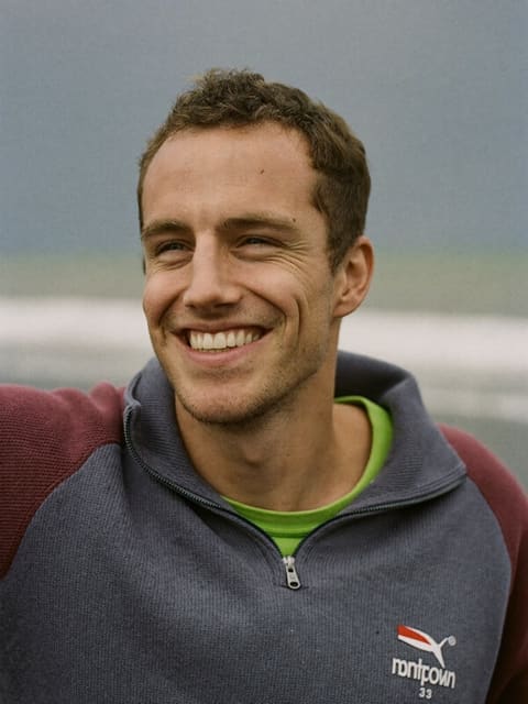 Portrait of James, a senior software engineer at Happydance, on Crosby beach