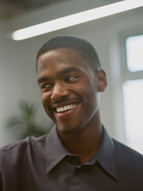 Portrait of Marcus, a graduate software engineer at Happydance and former teacher